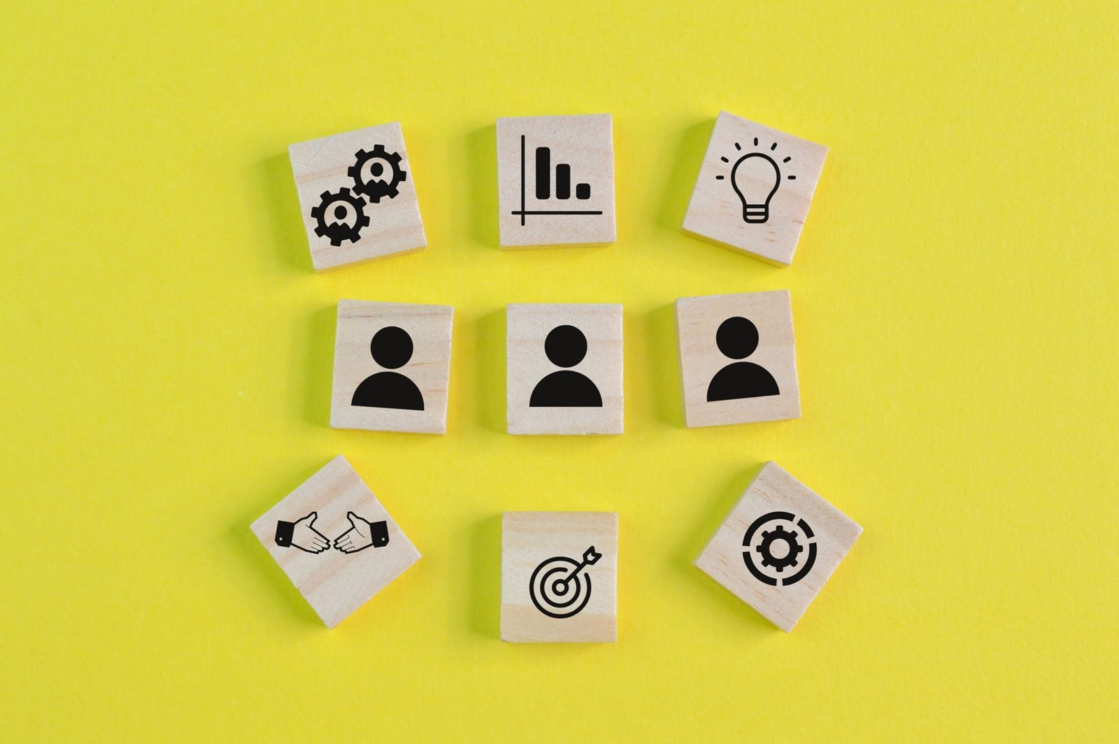 image with wooden blogs with symbols to represent people and business concepts